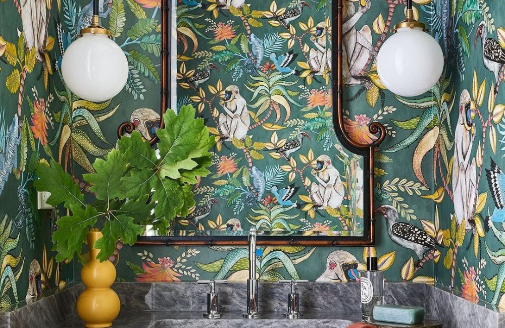 Uno specchio dal gusto orientaleggiante sullo sfondo di una wallpaper jungle